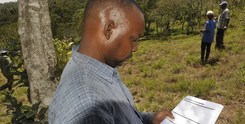 African man reading from a paper