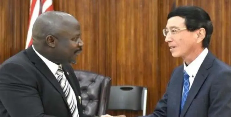 Acting Minister of Foreign Affairs, Hon. Gabriel H. Salee shaking hands with Ambassador of Japan to the Republic of Liberia, Mochizuki Hisanobu