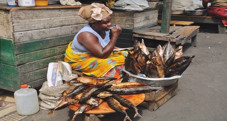 Women with fishes in an African market