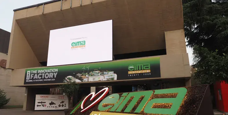 Event entrance with hoardings and digital boards displaying EIMA 2024.