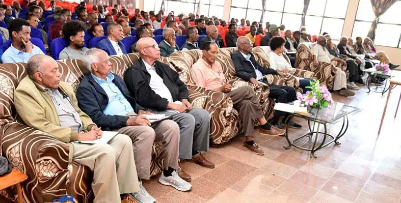 Attendees seated at the meeting.